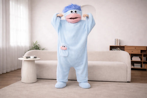 Person in a blue cartoon character costume standing in a living room.